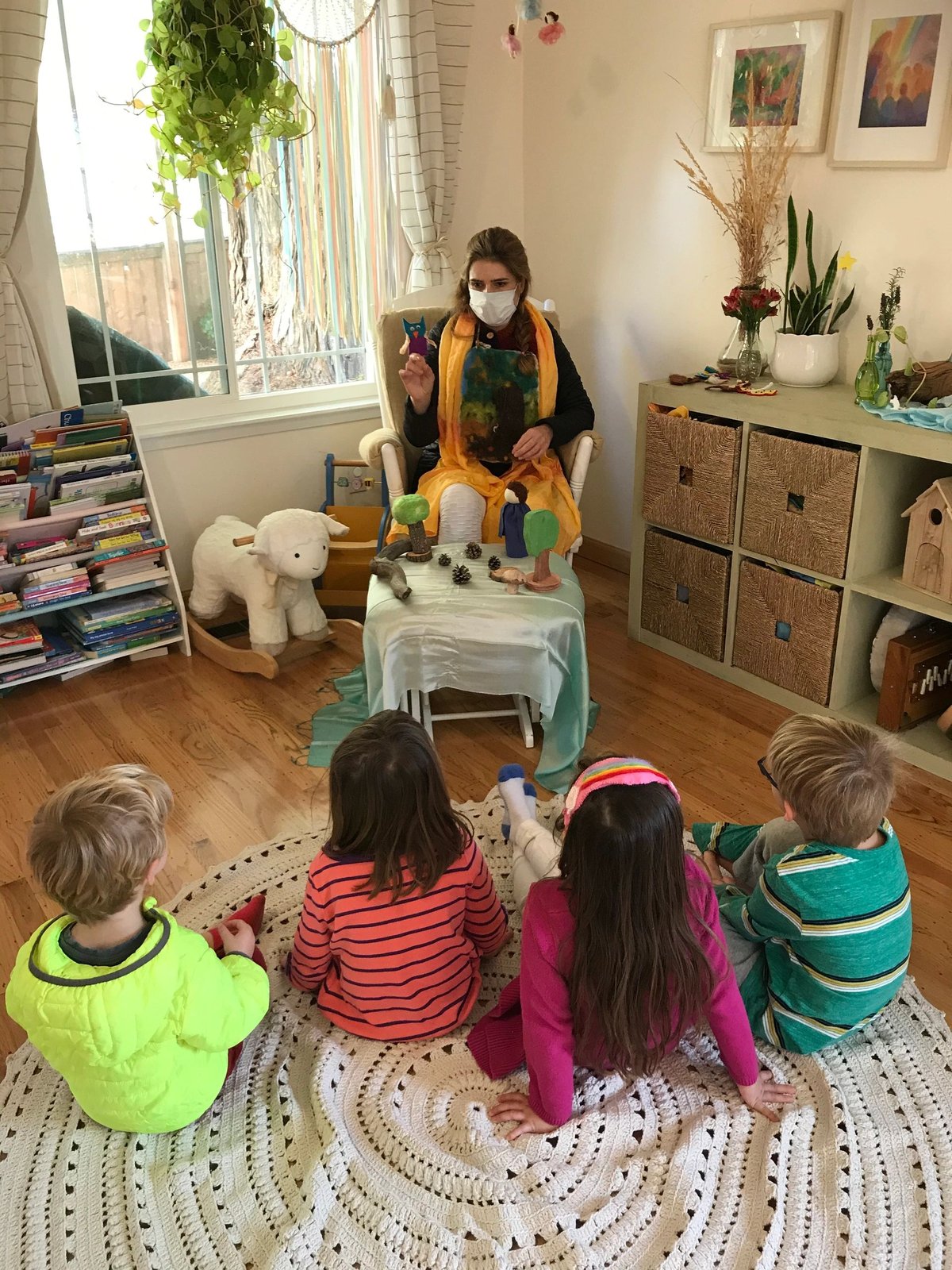 A teacher and children gathered for circle time on a round rug