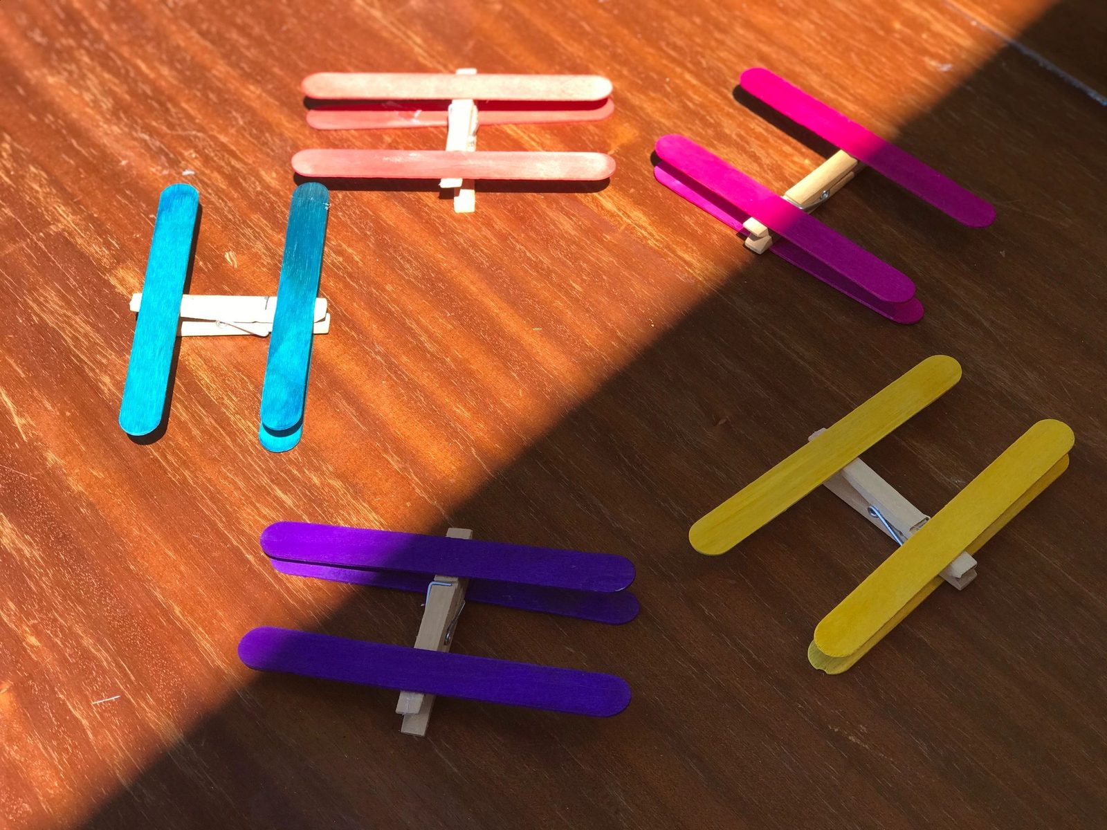 Colorful craft stick and clothespin shapes