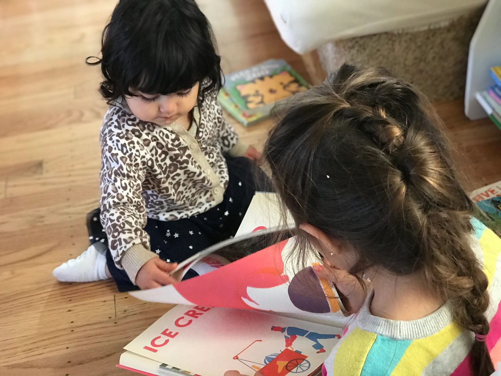Two children reading a book together